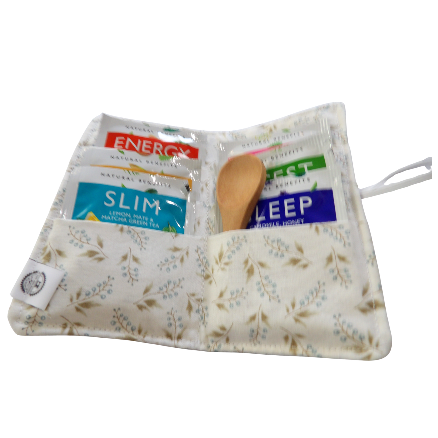 Fabric pouch with tea packages and a wooden spoon on a white background