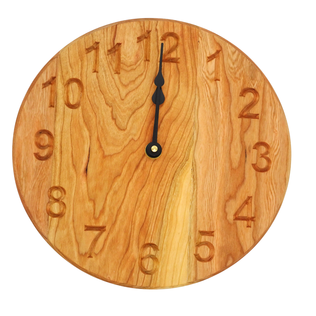 round cherry wooden wall clock with black spade hands and carved numbers