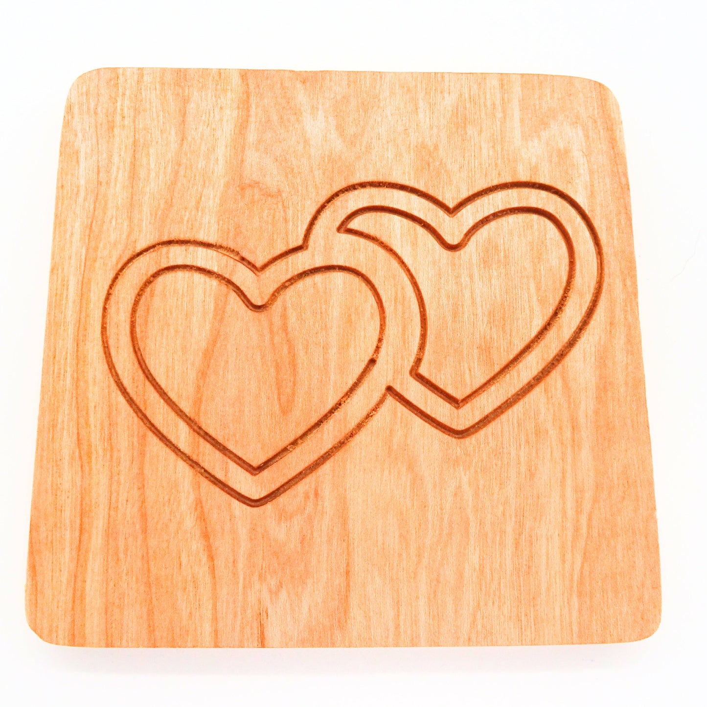 square cherry wooden coaster with two interlocking hearts engraved