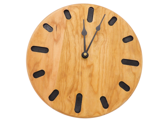 round cherry wooden wall clock with black oval hour markers and black spade hands