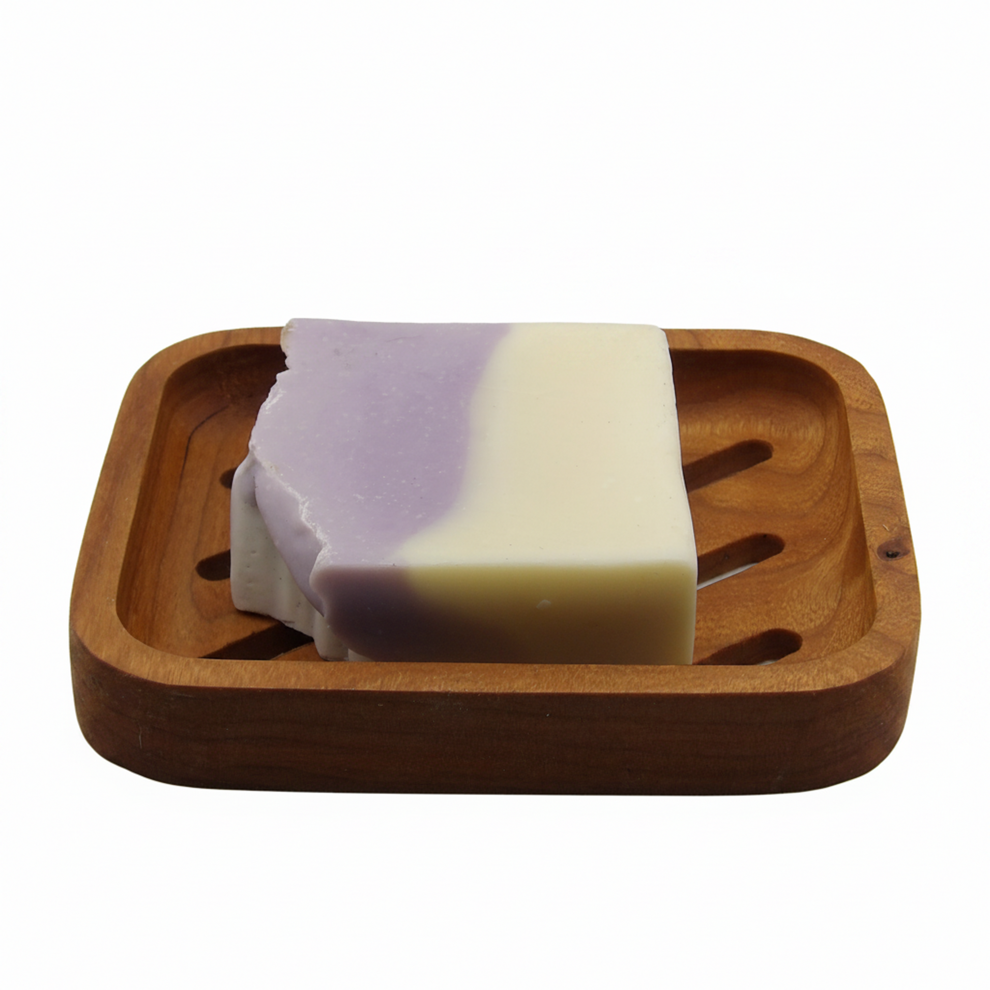 A rectangular bar of soap with a lavender-purple and cream color split, resting on a square wooden soap dish against a plain white background.