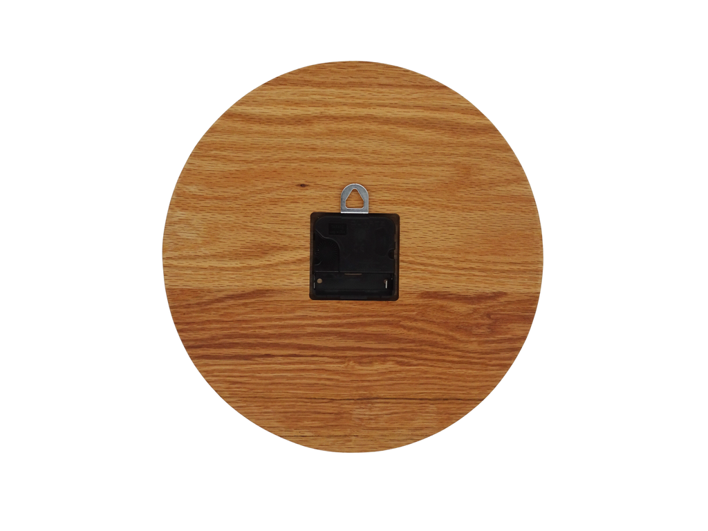 round oak wooden wall clock with black spade hands and carved numbers